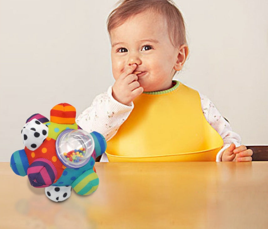 Baby hand catching rattle ball